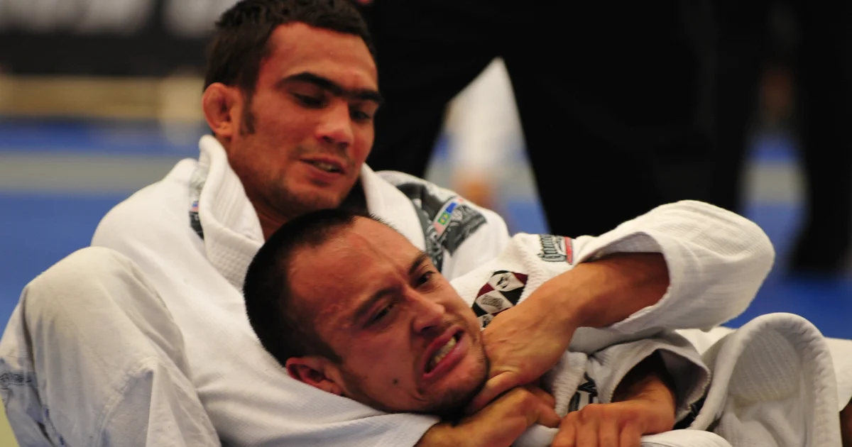 Gi BJJ competitor executing a bow-and-arrow choke alongside a no-gi grappler hunting an inside heel hook — the two dominant finish archetypes in each format.