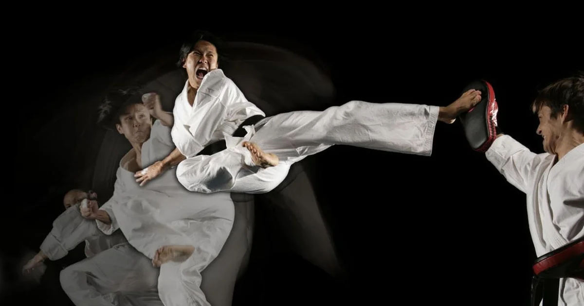 Spinning back kick technique — fighter pivoting on the support foot while driving the heel directly backward at midsection height, heel locked, knee fully extended toward target