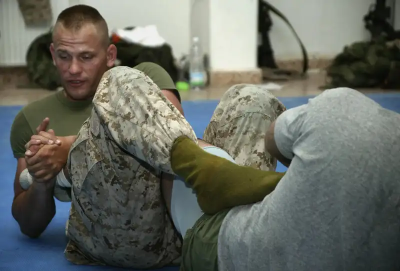 A U.S. Marine demonstrating a heel hook during a Brazilian Jiu-Jitsu class — the same leg lock submission that the Imanari roll is designed to access. Public domain, U.S. Marine Corps photo by Cpl. Joel A. Chaverri
