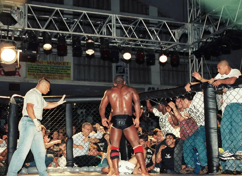 Eugenio Tadeu standing over grounded Renzo Gracie at Pentagon Combat Vale Tudo 1997 — the definition of what counts as a "grounded" fighter has been one of the most debated rules in MMA history. Public domain via Wikimedia Commons